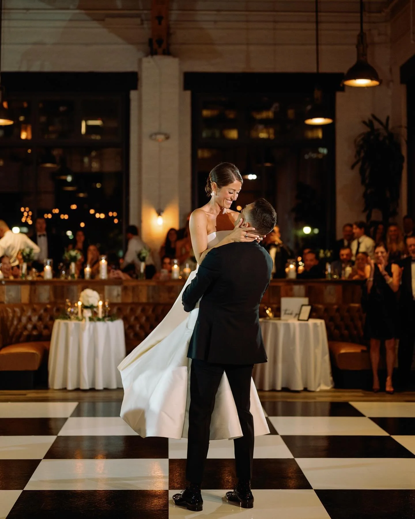 Couple dancing on black and white checkered dance floor