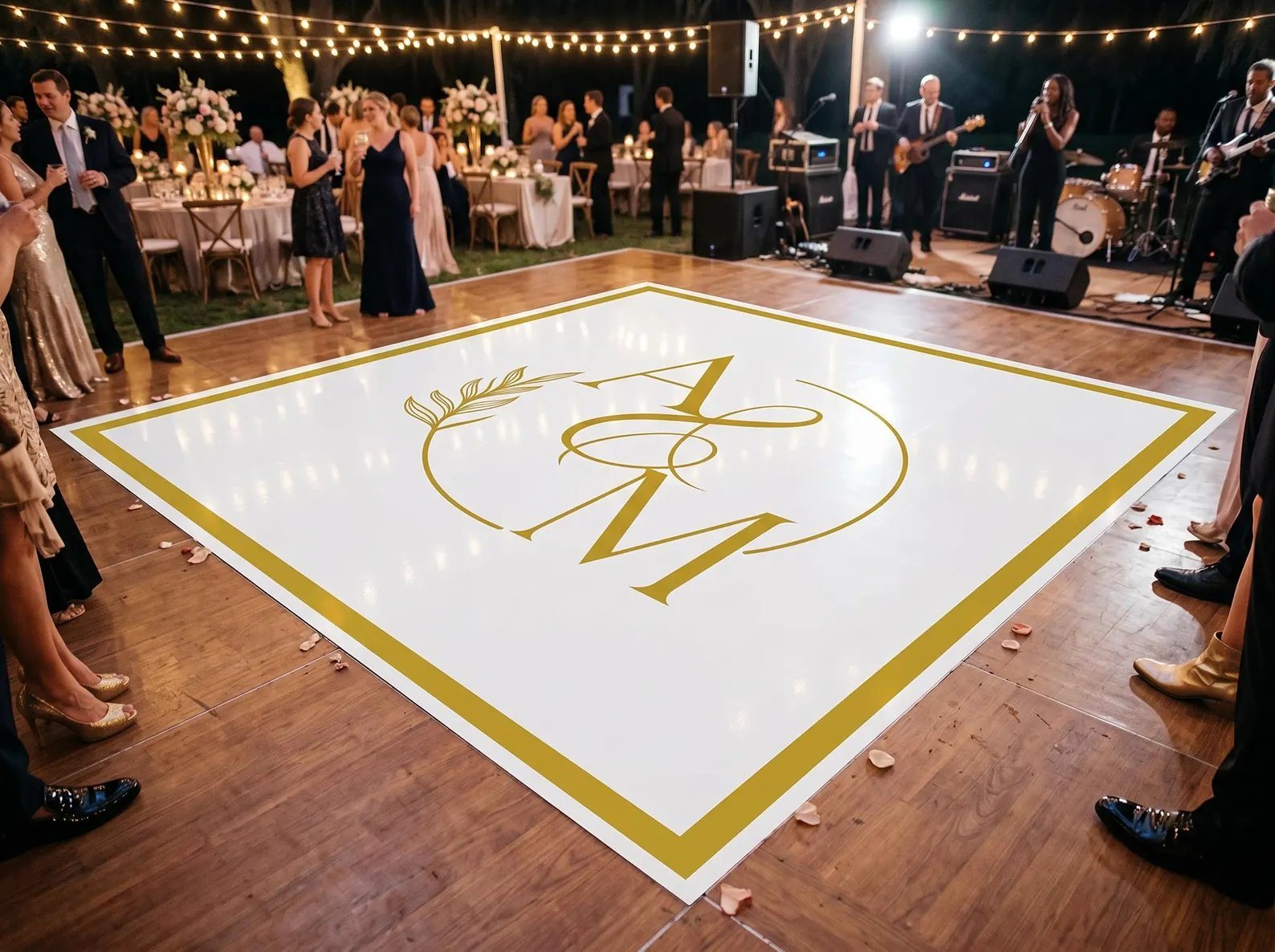 Custom white and gold monogram vinyl wrap dance floor at an outdoor Oklahoma City wedding reception