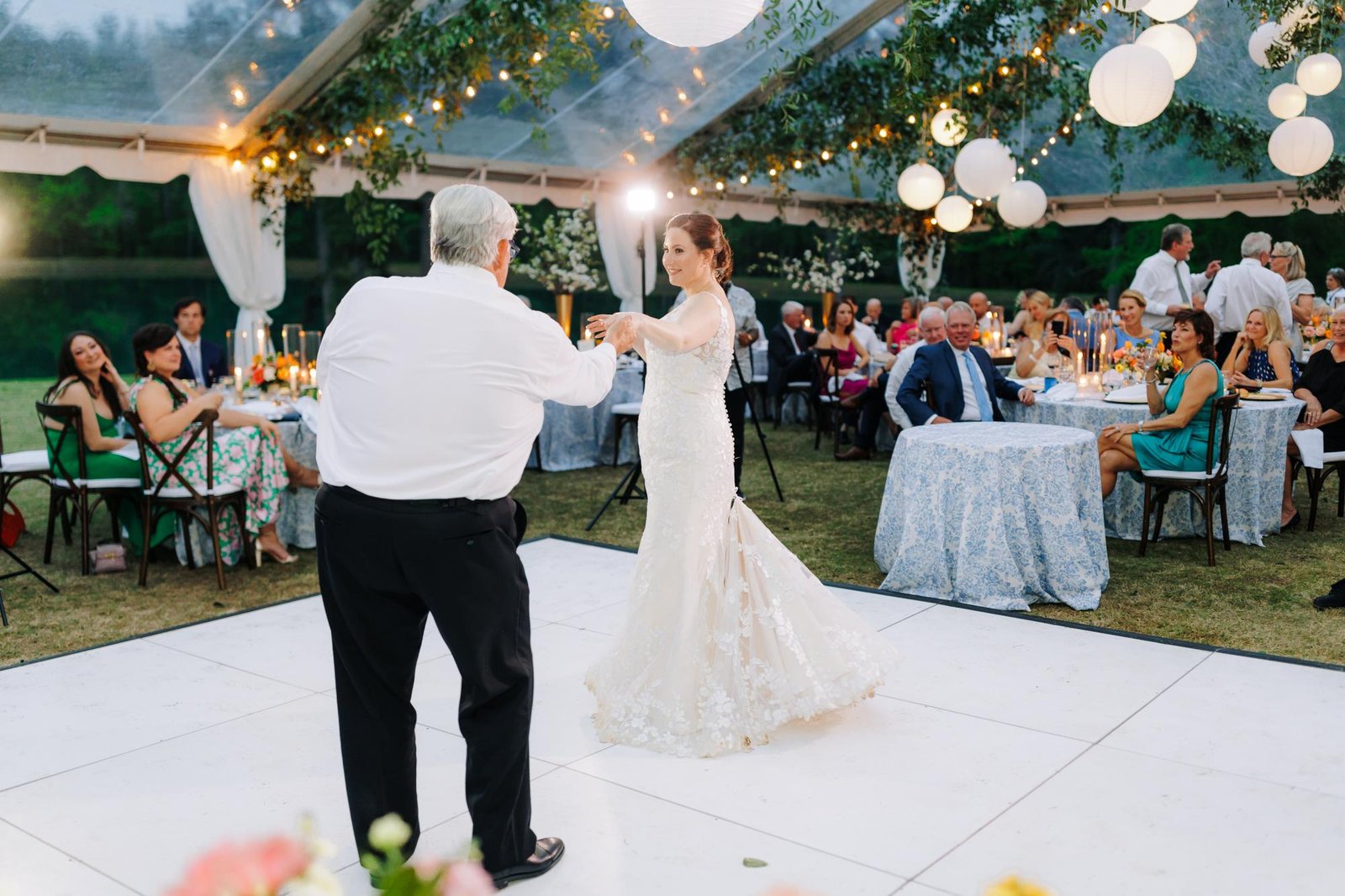All white dance floor set up under a tent for an Oklahoma City wedding reception